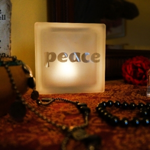 Glass block glass tealight candle holder with peace motif