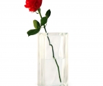 Tall clear glass vase with single red rose
