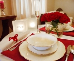 Romantic dinner with glass block tealight candle holders and glass vase with roses
