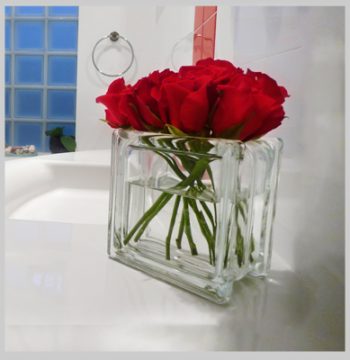 Glass block vase with red roses