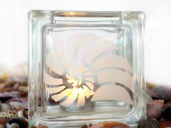 glass tea light candle holder with spiral shell motif
