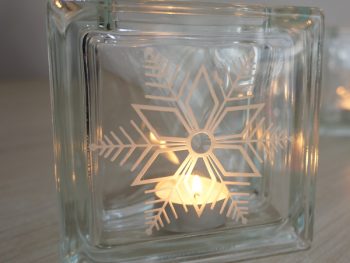 Glass block tea light candle holder with snowflake design